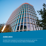 A modern curved office building with a glass curtain wall under a clear blue sky, with a blue text banner at the bottom reading 'AAMA 2604' and descriptive copy about architectural aluminum finish.